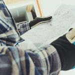 Close up of electrical apprentice studying plans