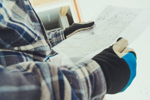 Close up of electrical apprentice studying plans