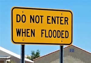 flood sign represnting that standing water can result in electrical emergencies